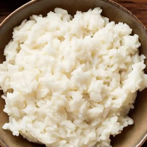 Close-up of a bowl of fluffy, glossy sushi rice ready for rolling or serving.