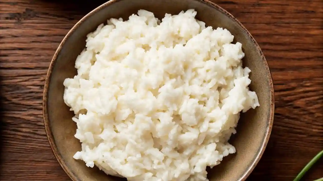 Close-up of a bowl of fluffy, glossy sushi rice ready for rolling or serving.