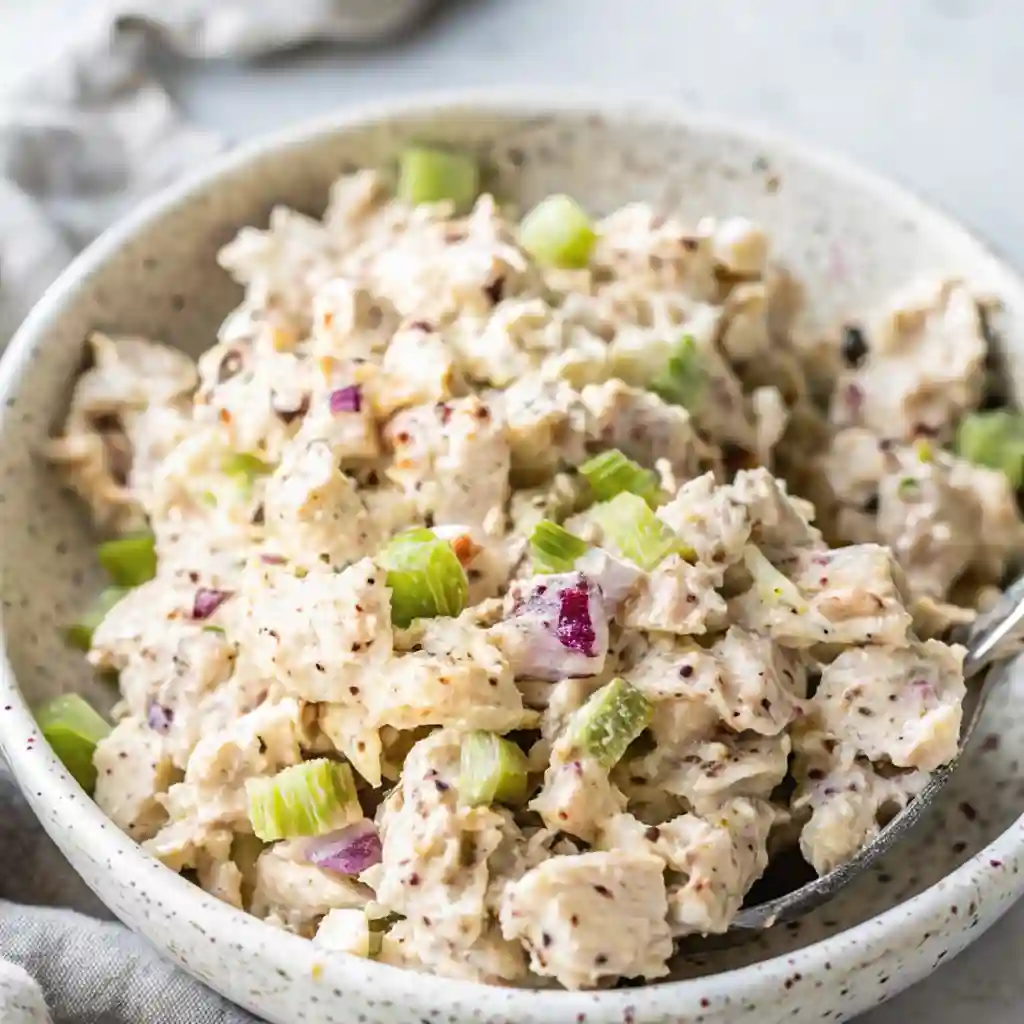 Bowl of easy chicken salad with celery and red onion