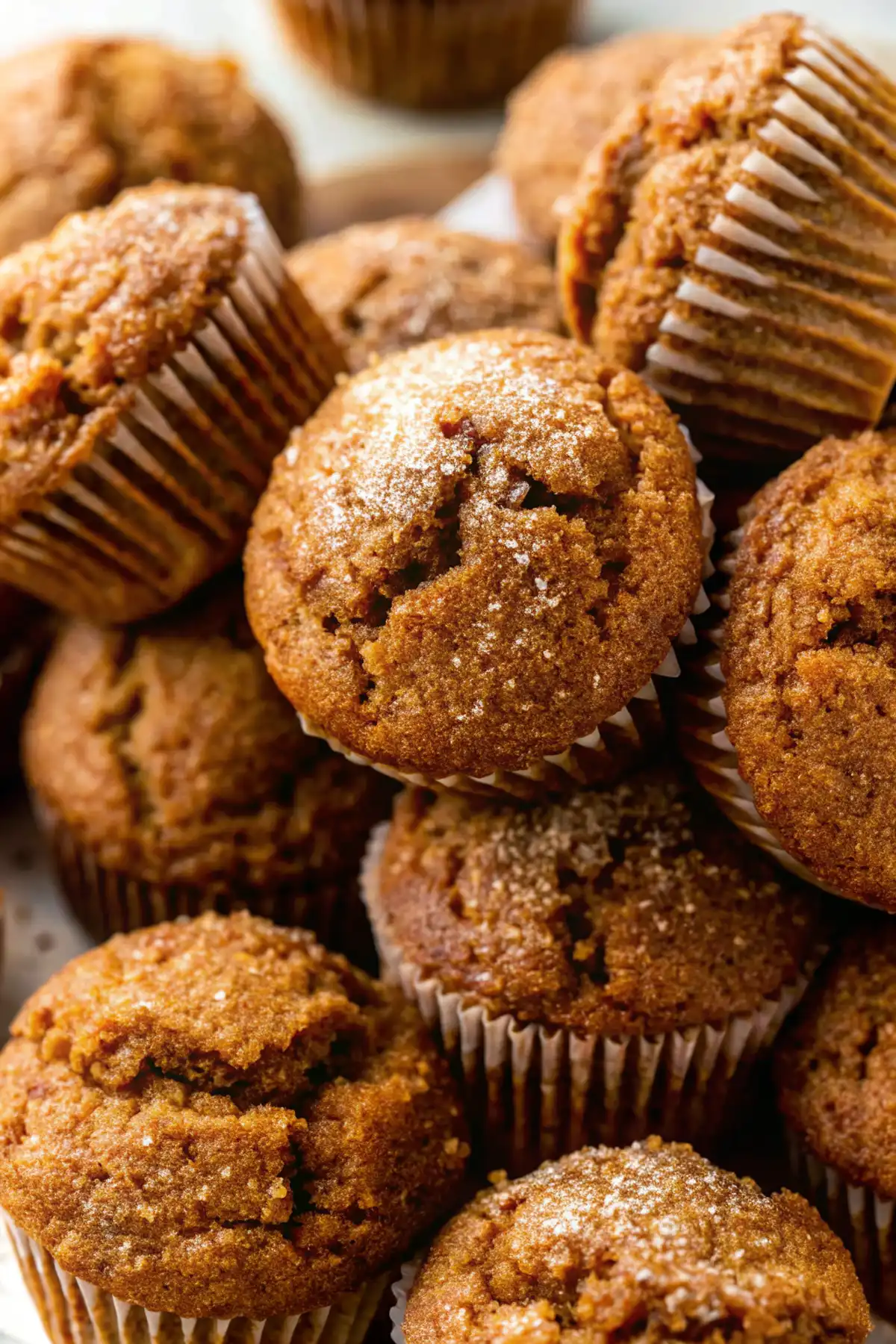 Close-up of homemade pumpkin muffins with cracked tops and a sprinkle of sugar
