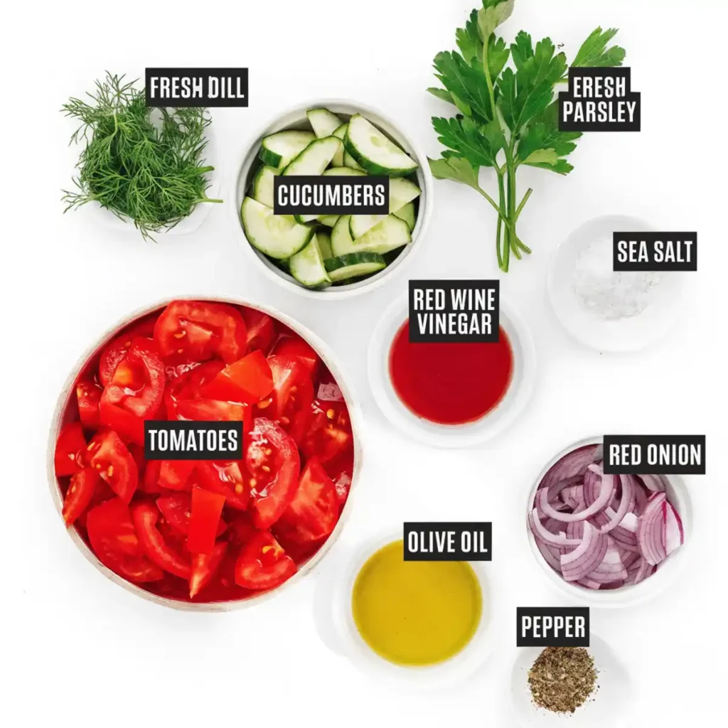 Cucumber tomato salad ingredients including tomatoes, cucumbers, red onion, fresh dill, parsley, olive oil, red wine vinegar, sea salt, and pepper.