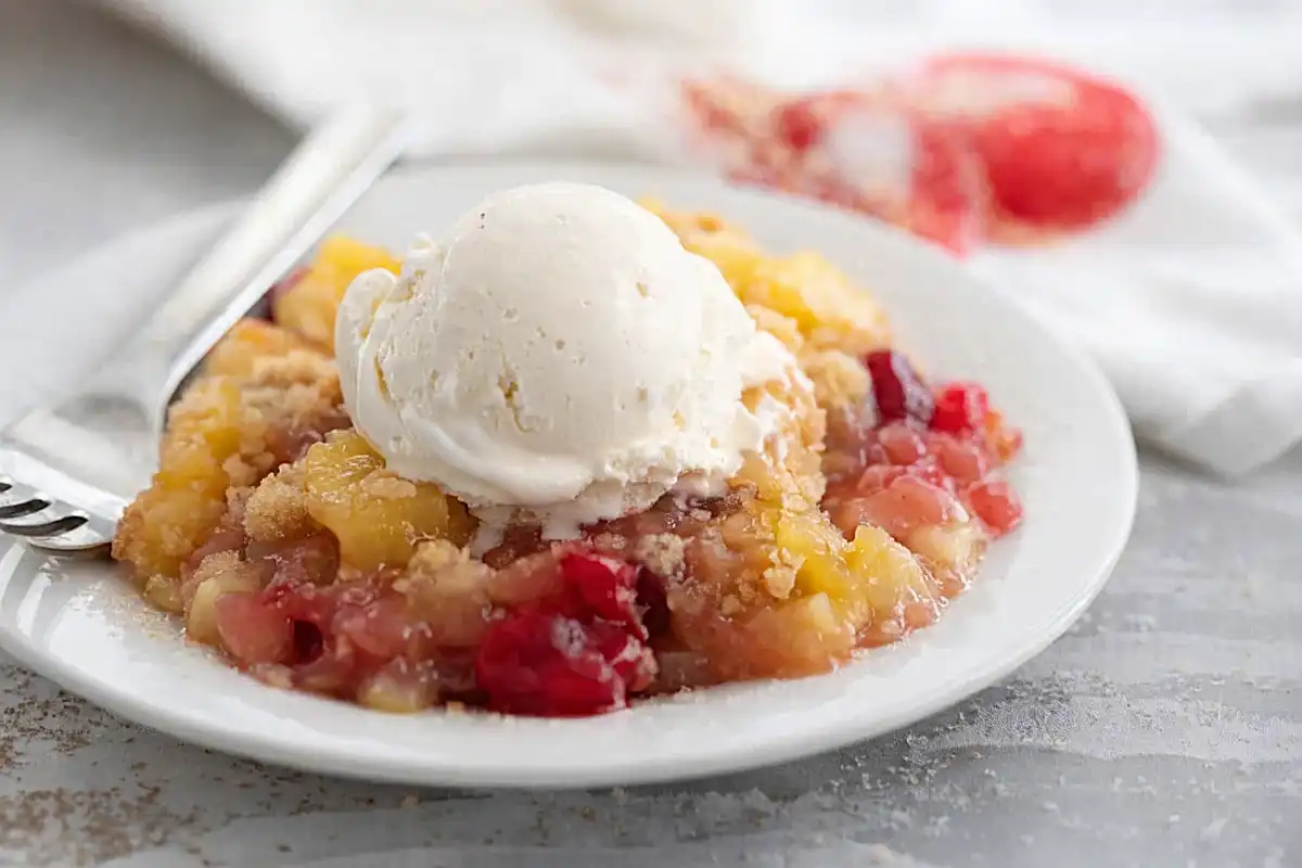dump cake recipe with cherry pineapple filling and vanilla ice cream on top