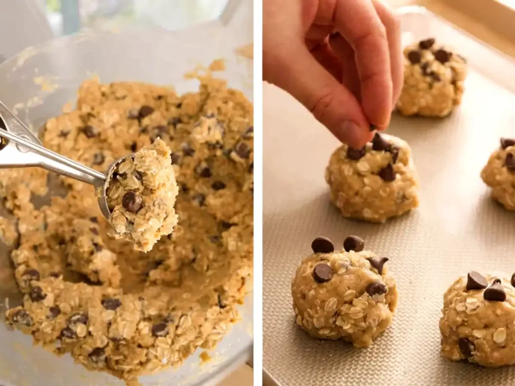 Best oatmeal chocolate chip cookies dough being scooped from a bowl and topped with extra chocolate chips on a baking tray before baking.