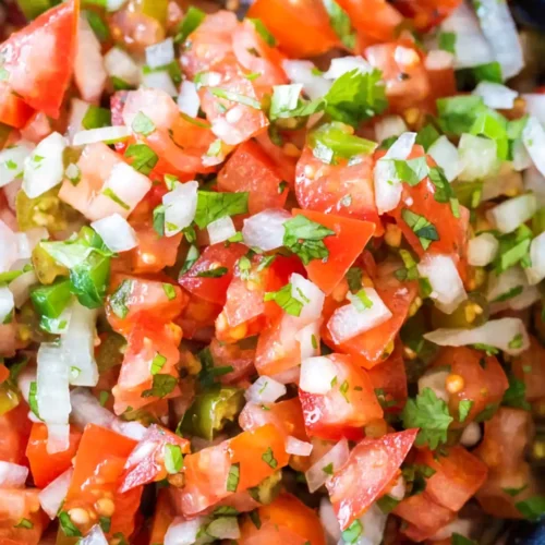 Fresh pico de gallo with diced tomatoes, onion, jalapeño, and cilantro in a bowl