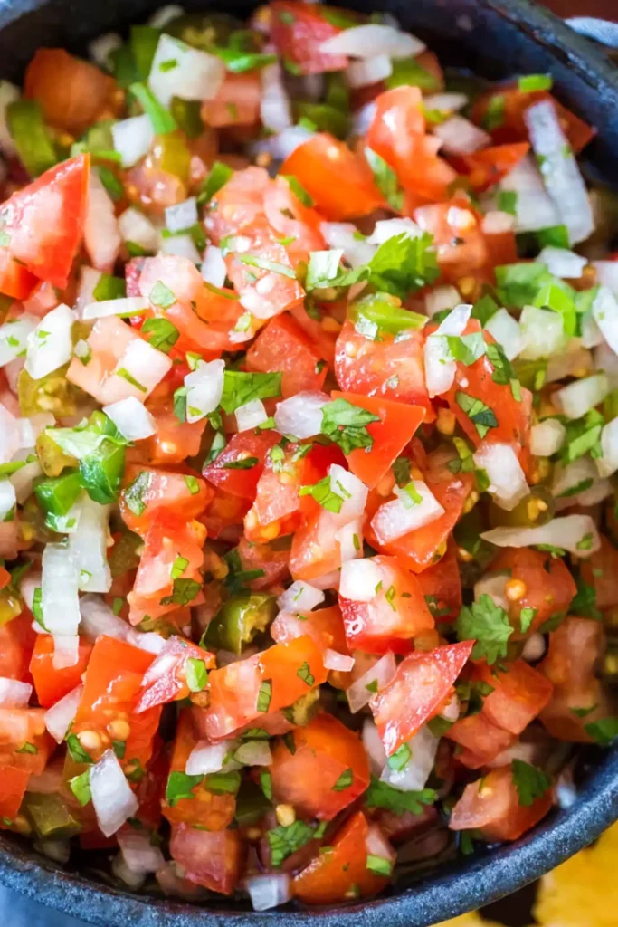 Fresh pico de gallo with diced tomatoes, onion, jalapeño, and cilantro in a bowl
