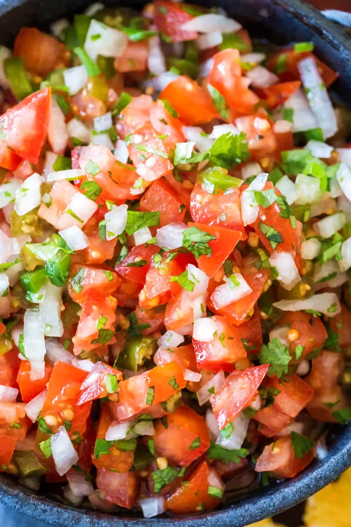 Fresh pico de gallo with diced tomatoes, onion, jalapeño, and cilantro in a bowl