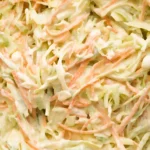 Creamy homemade coleslaw made with shredded green cabbage and carrots mixed in a rich coleslaw dressing.