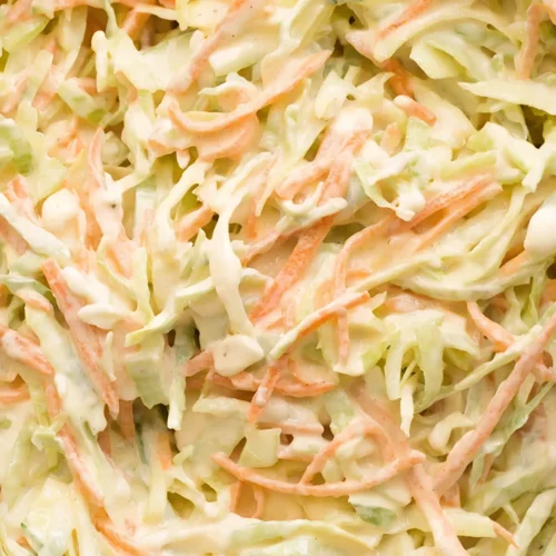 Creamy homemade coleslaw made with shredded green cabbage and carrots mixed in a rich coleslaw dressing.