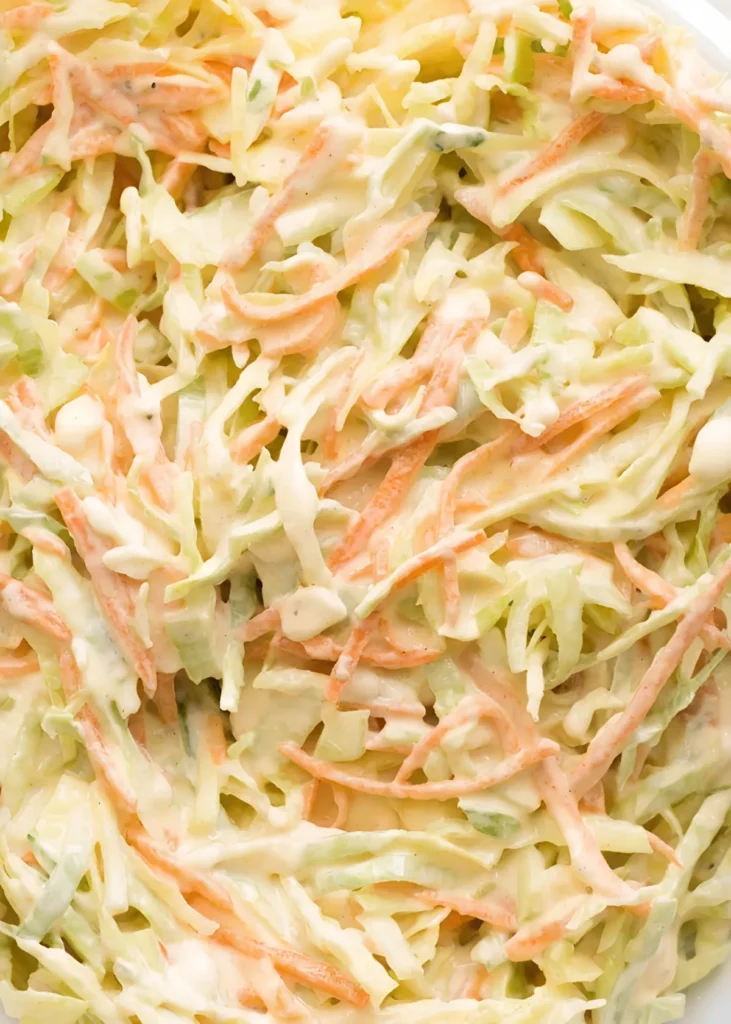 Creamy homemade coleslaw made with shredded green cabbage and carrots mixed in a rich coleslaw dressing.
